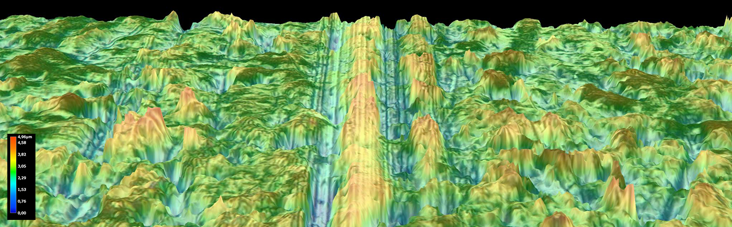 SEM image of a furrow caused by particles on the slide valve of a rotary compressor.